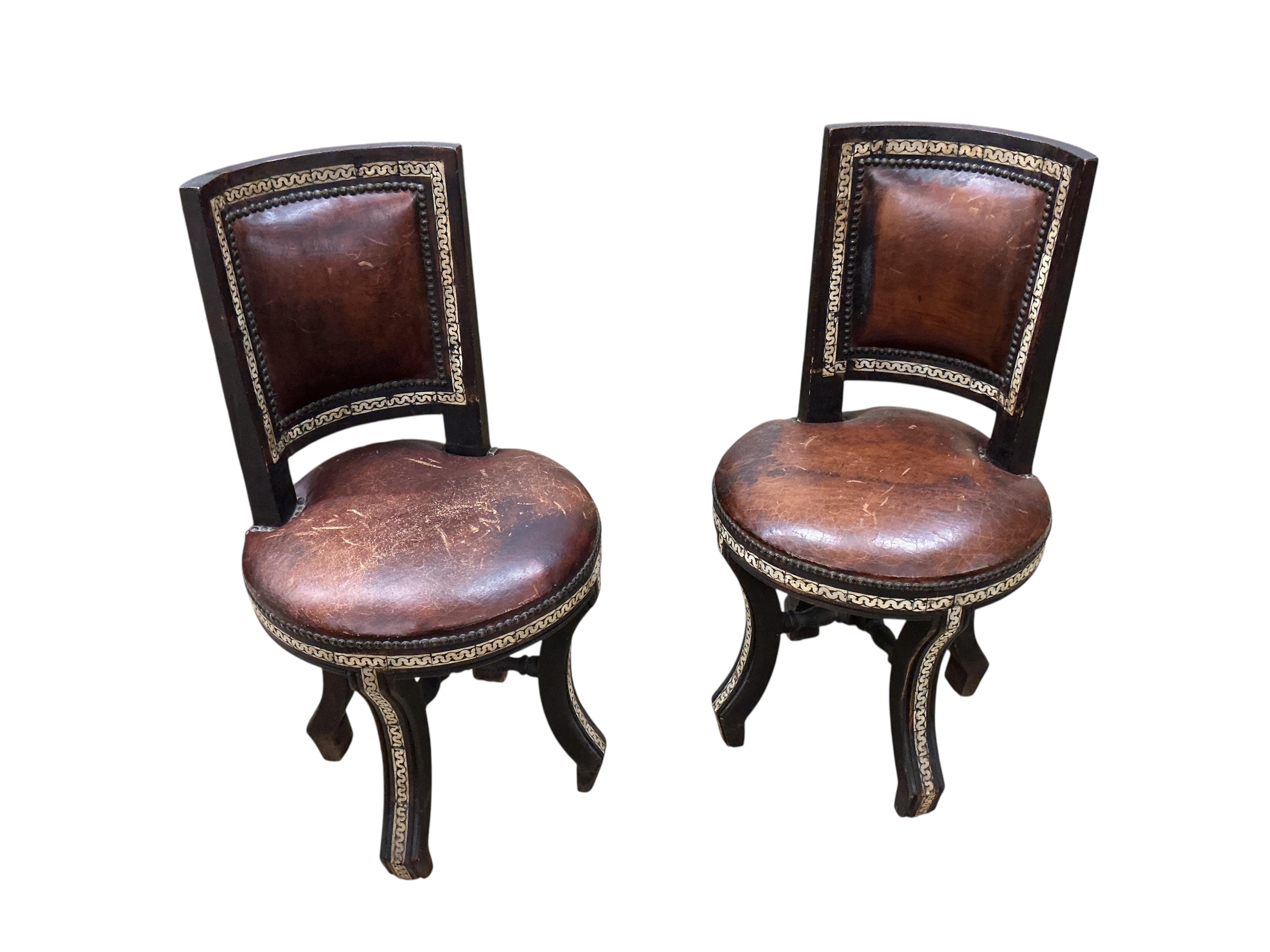 A Moroccan circular studded cedar glass top bistro table, diameter 80cm, height 76cm together with two matching chairs